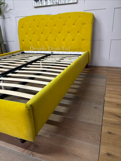 Joules Windsor king-size bed frame in mustard yellow velvet from DFS, featuring a button-backed Chesterfield headboard and turned wooden legs.