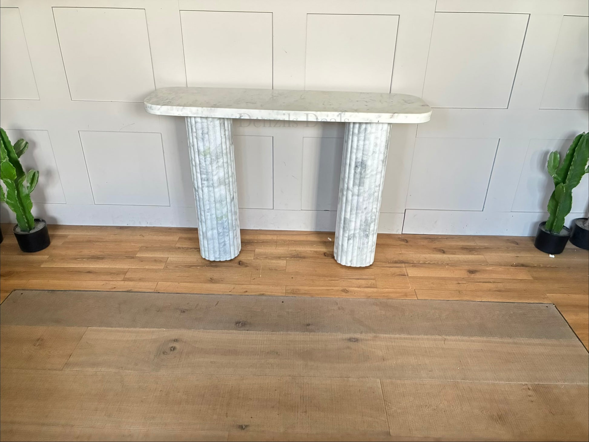 The Kanta fluted marble console table from Anthropologie, featuring sculptural block legs and a smooth rectangular top in natural stone