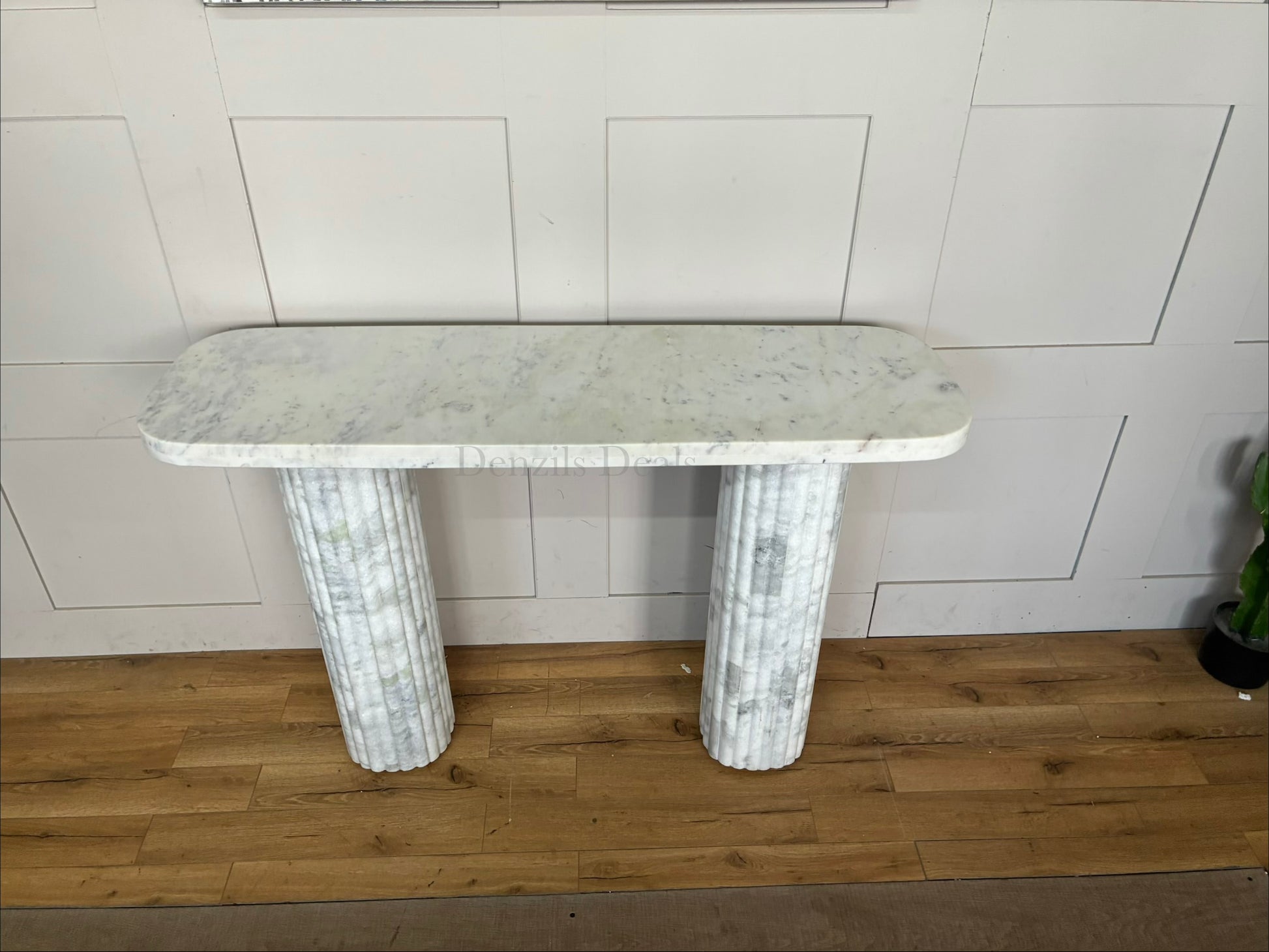 The Kanta fluted marble console table from Anthropologie, featuring sculptural block legs and a smooth rectangular top in natural stone