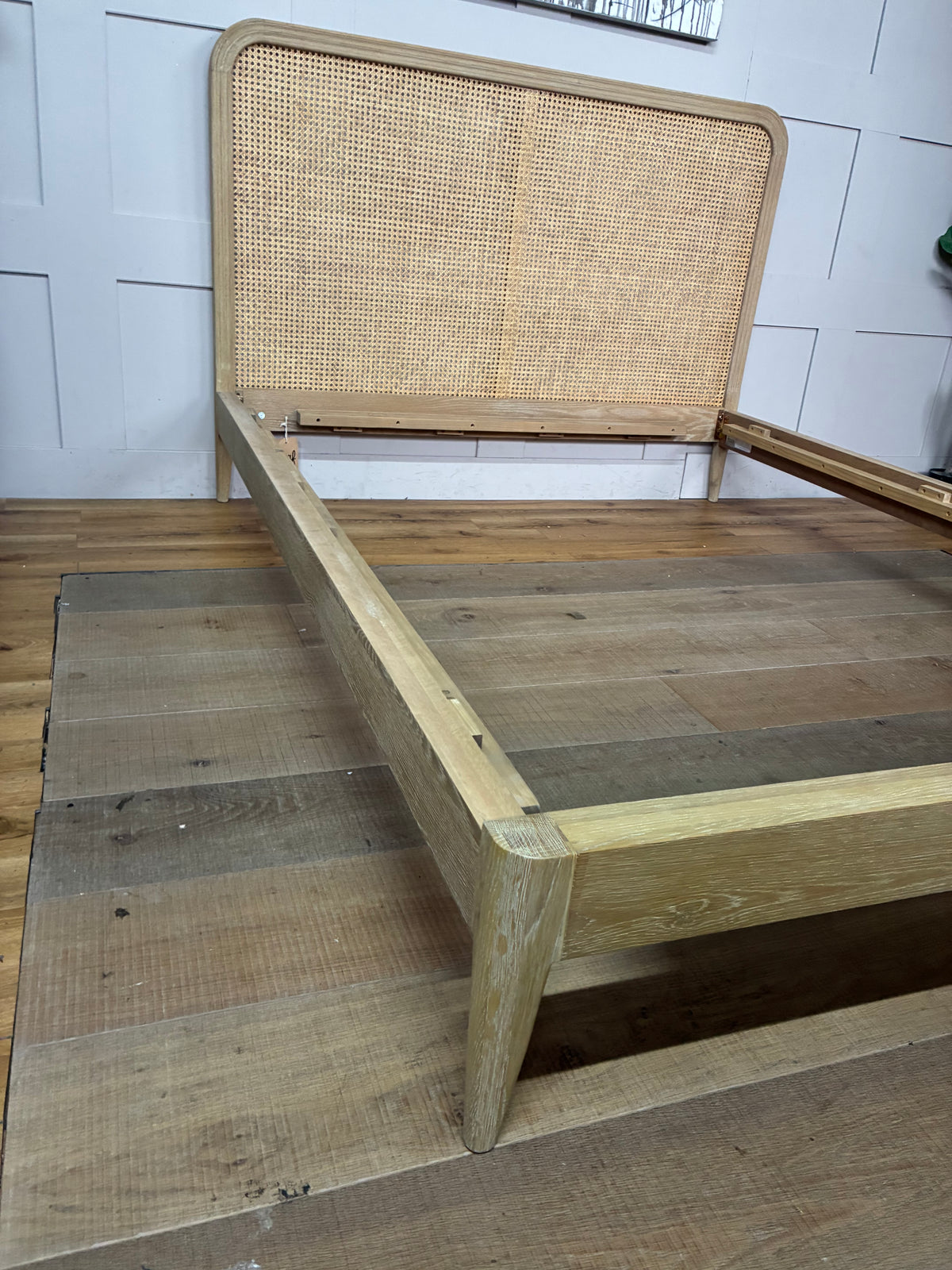 King-size Loaf Ribbon bed frame crafted from light natural oak wood, featuring a clean-lined, Scandi-inspired headboard with woven rattan detailing.