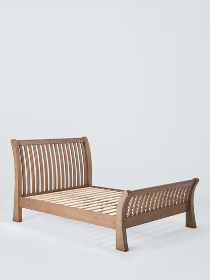 King-size bed frame made from reclaimed natural timber wood, featuring a rustic headboard with unique grain patterns, a sturdy low-profile base, and warm honey-brown tones.