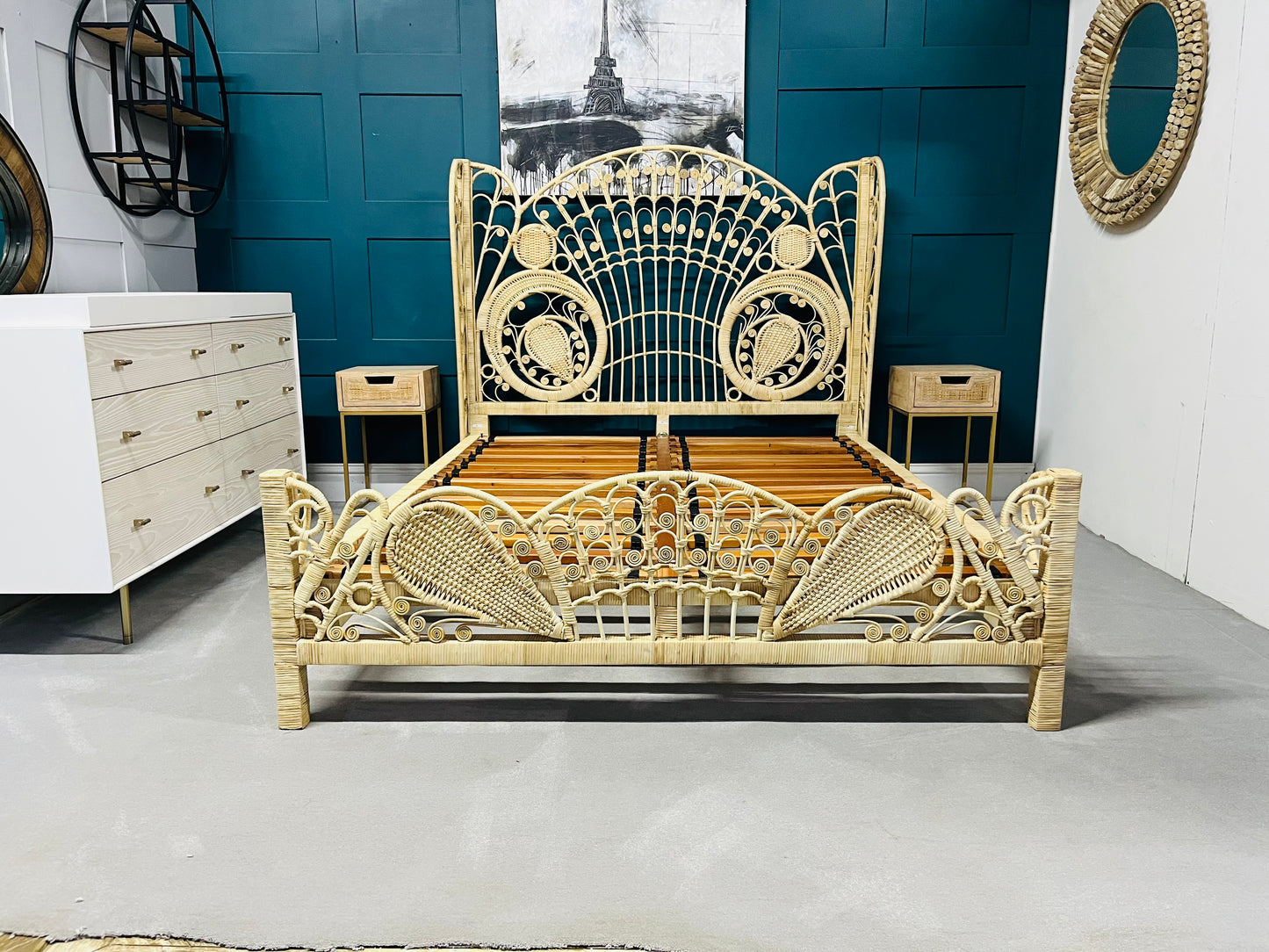 King size Kinsella rattan bed with a natural finish, featuring a high, fan-shaped headboard with intricate feminine filigree weaving and a powder-coated steel frame