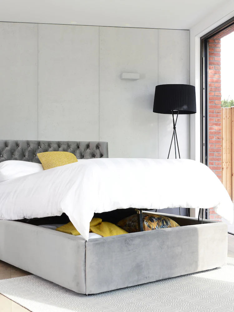 King size dwell Cavendish II ottoman bed in grey flat weave fabric, featuring a tall, curved, and deep-buttoned headboard