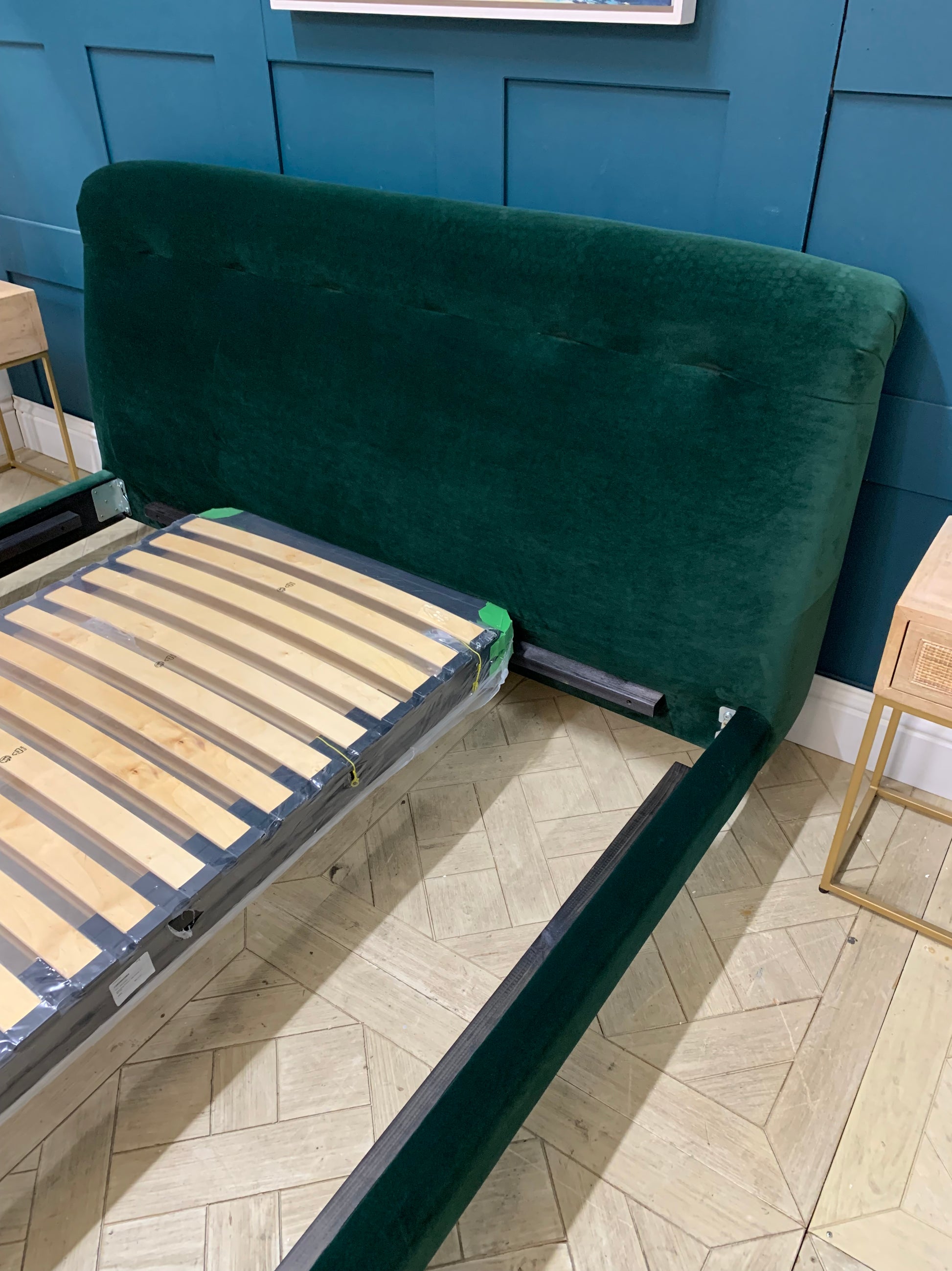  Superking size Slumbleton bed by Loaf, upholstered in "Christmas Tree" dark green Clever Velvet. It features a tall, slightly angled headboard with soft, rounded edges and a slatted base.
