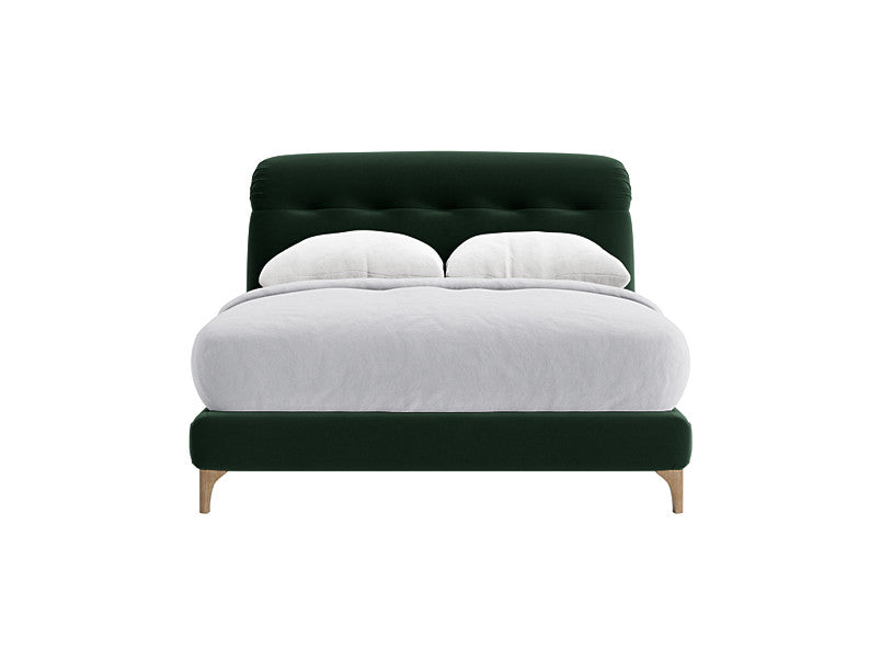 A deep green velvet superking bed frame with a raked, upholstered headboard.