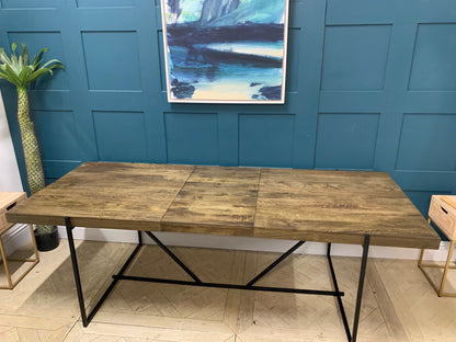 Close-up of the rich dark mango wood grain and smooth finish of the MADE Morland dining table.