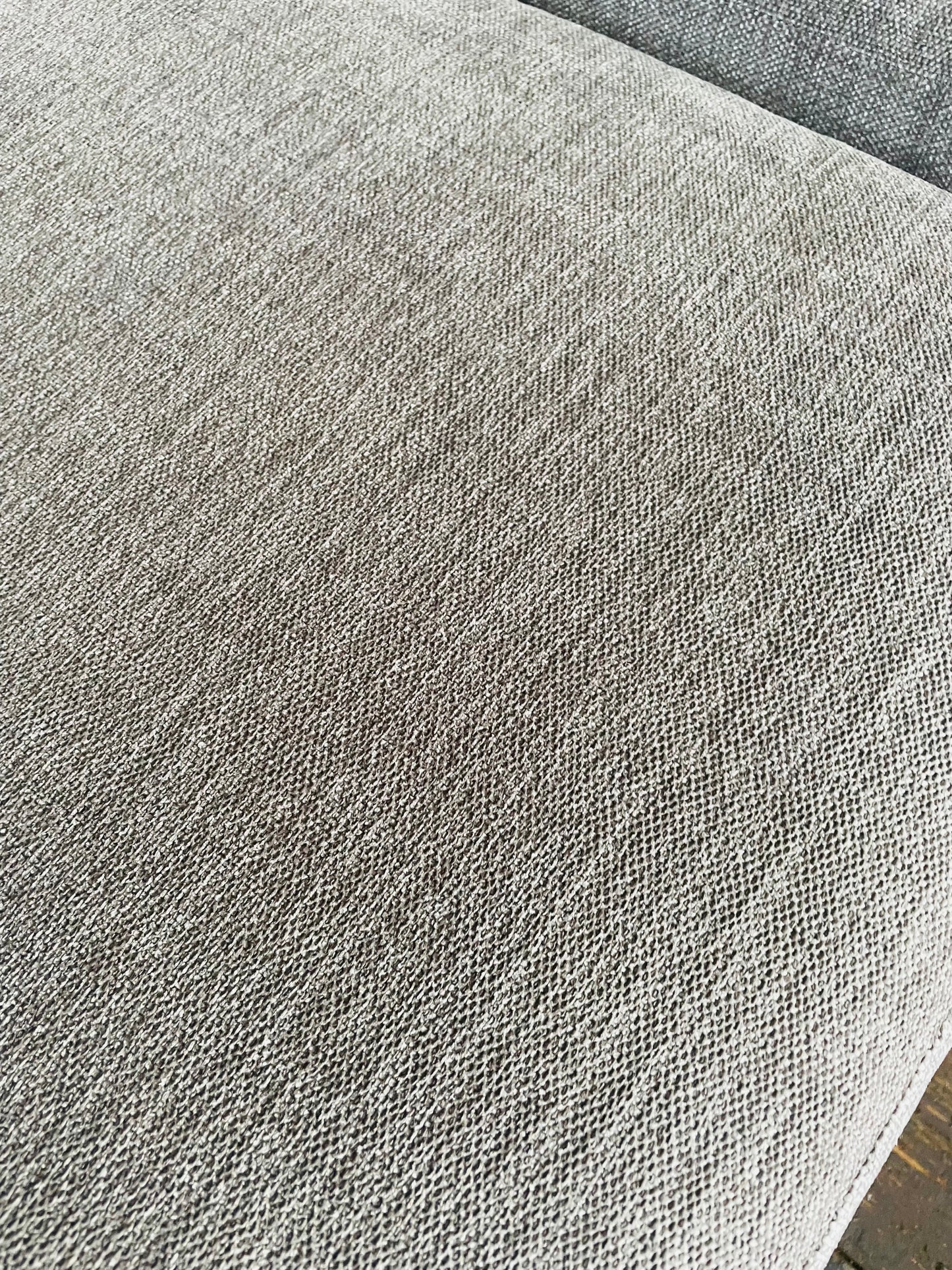 Macro view of the chunky, neutral-toned Opal Putty woven chenille fabric on the John Lewis Laze sofa." 