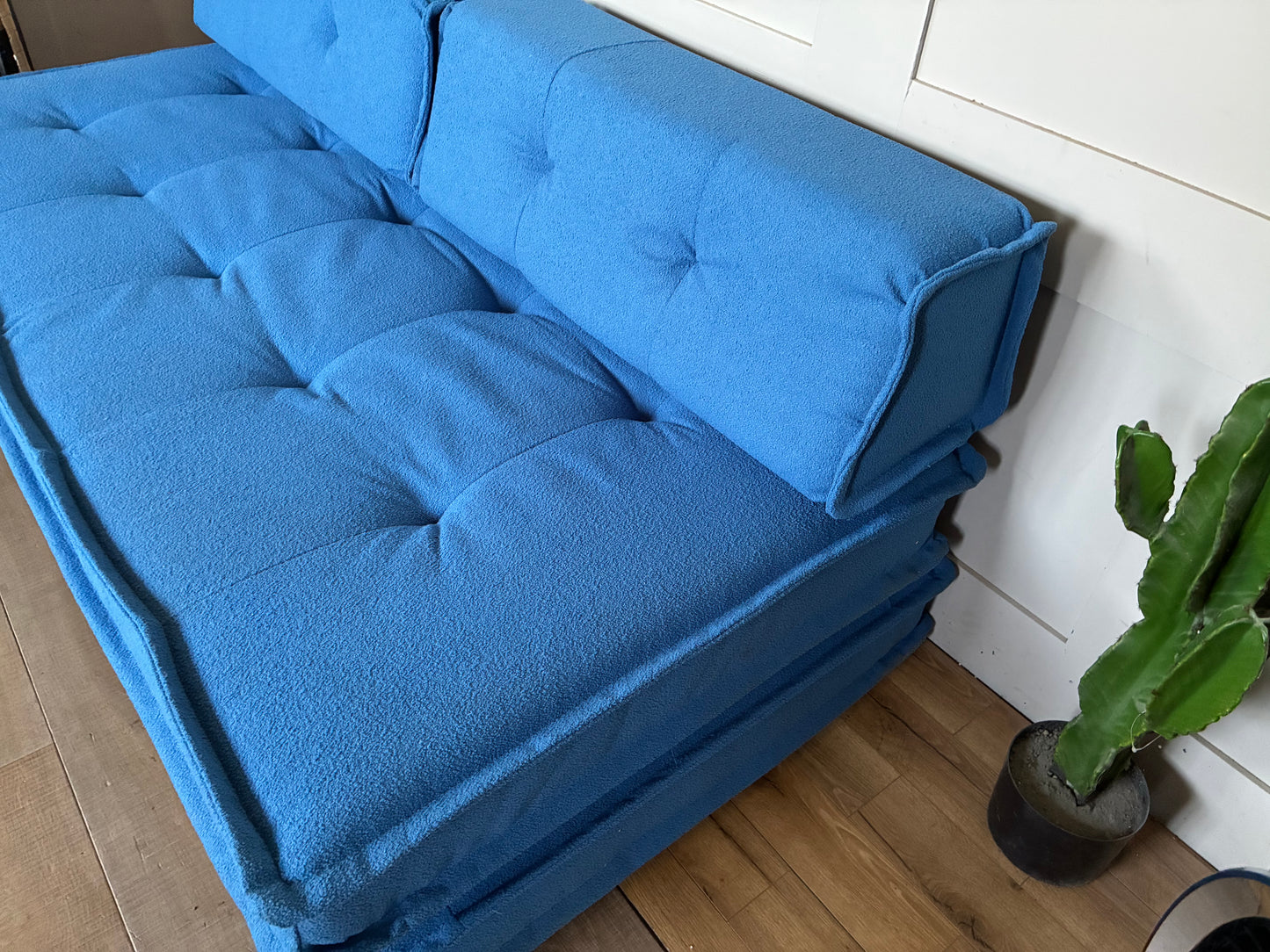 Blue contemporary Macy double sofa bed converted into a spacious floor-level sleeper."
