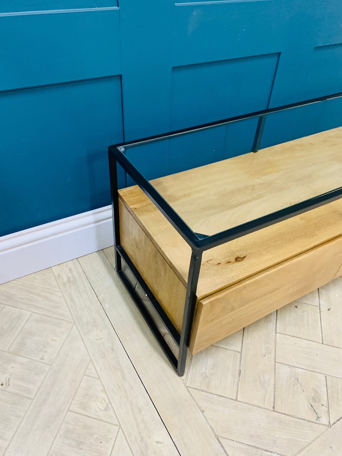 Made.com Kilby Wide TV Stand in light mango wood with smoked glass top and black metal frame.