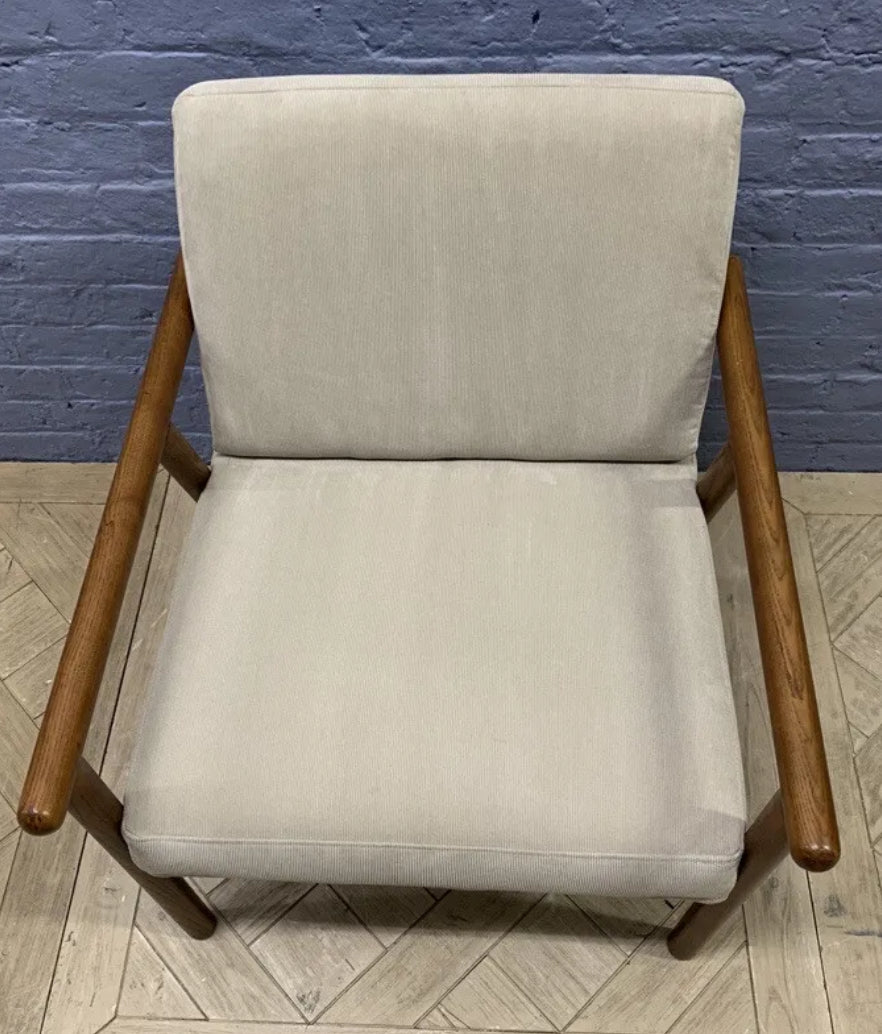Mid-century style Lars accent chair in stone grey fabric and dark walnut wood finish.
Made.com Lars armchair, stone microfibre and walnut.