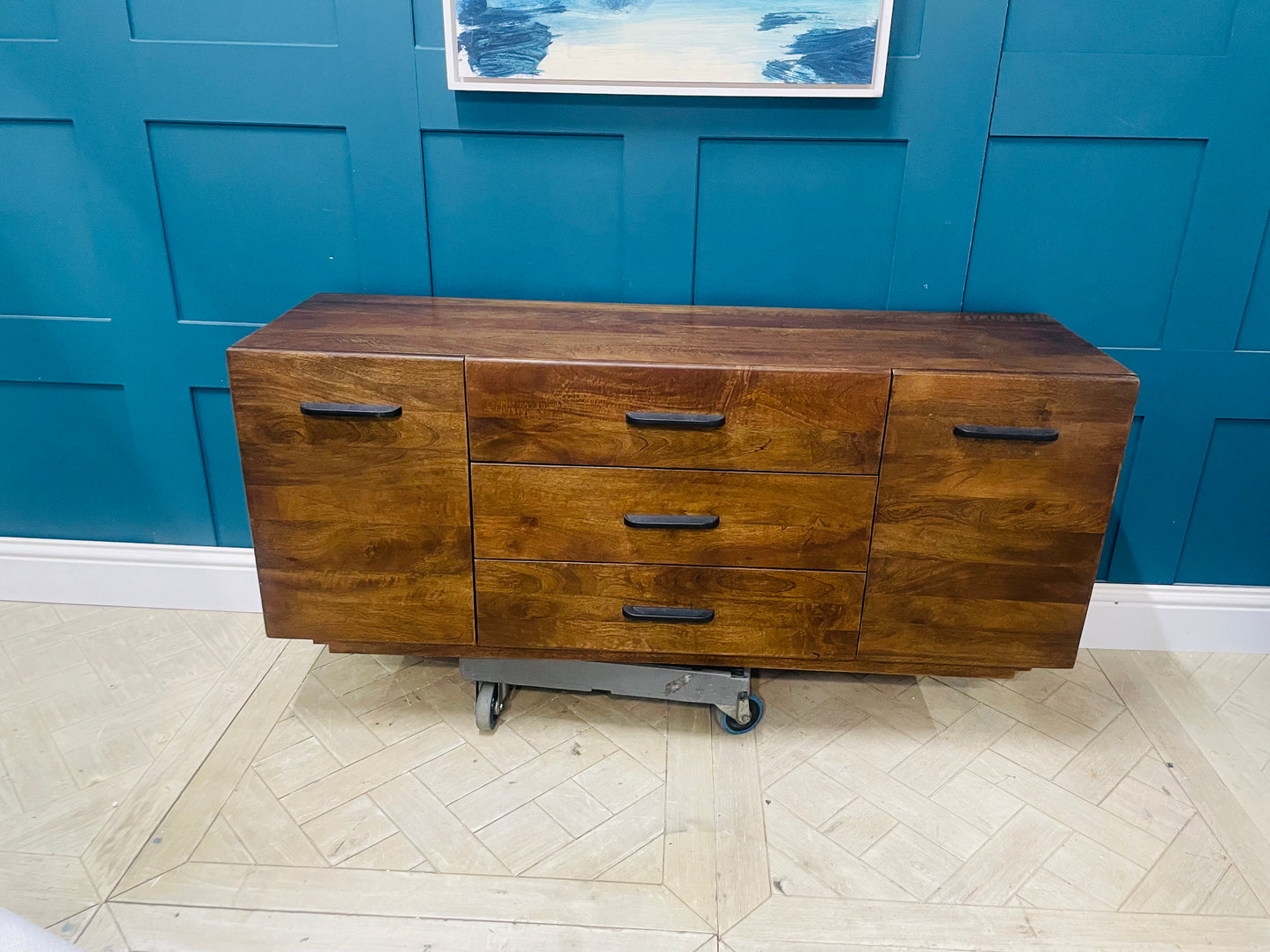Modern Lucien large dark mango wood sideboard styled in a contemporary living room. Legs included 