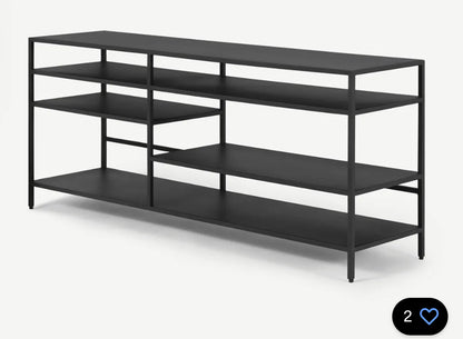 Made.com Munro TV shelving unit in a brushed brass-effect finish, featuring a minimalist industrial design with open storage shelves for media devices and home decor.