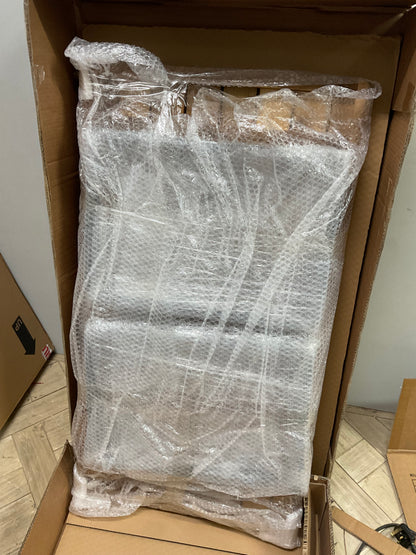 Made.com Topa garden armchair and low coffee table set in solid acacia wood with charcoal grey cushions on a patio.