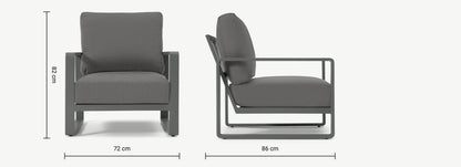 Made.com Topa garden armchair and low coffee table set in solid acacia wood with charcoal grey cushions on a patio.