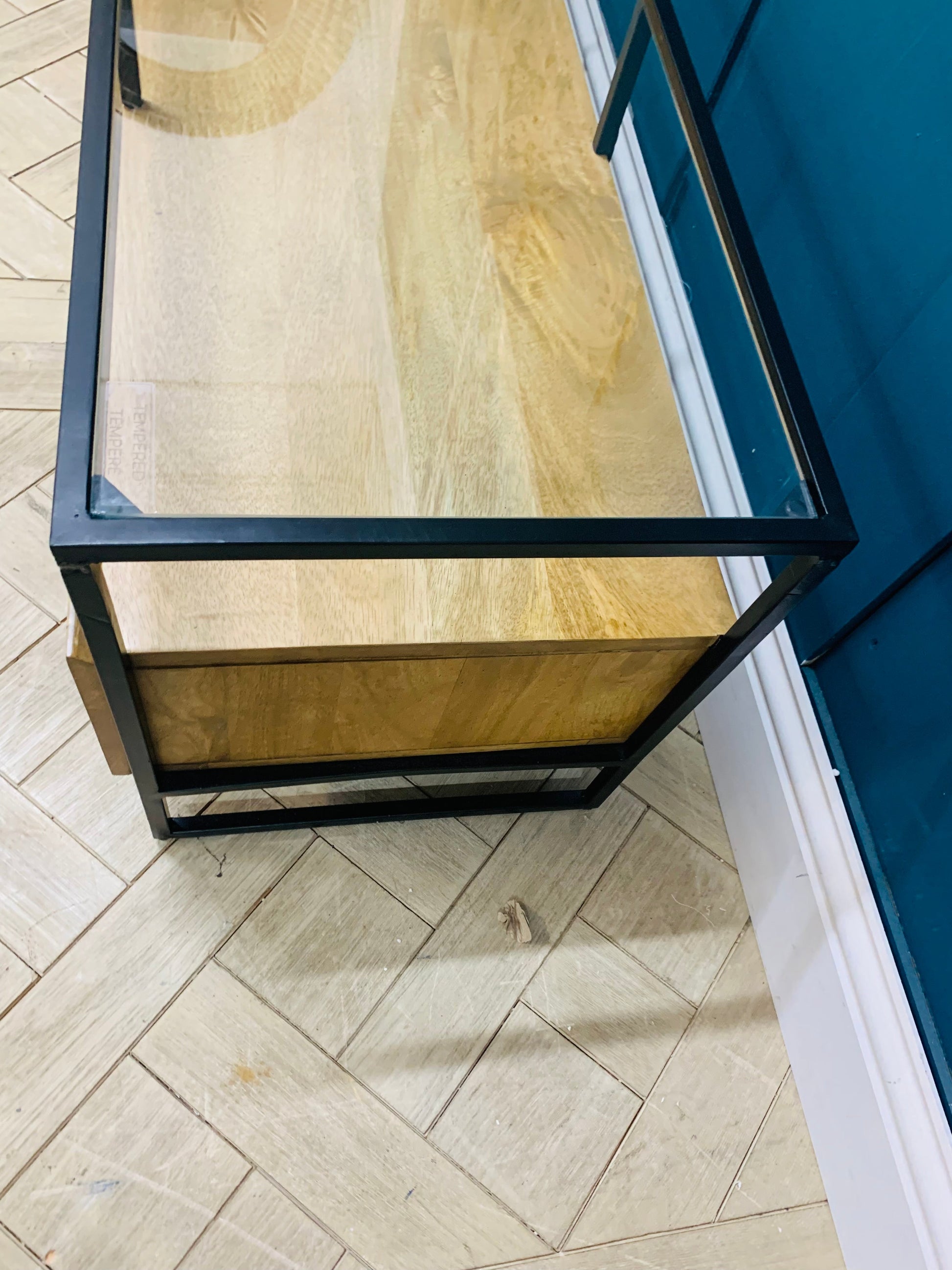 Made.com Kilby wide TV stand in light mango wood featuring textured fluted glass sliding doors and tapered legs.
