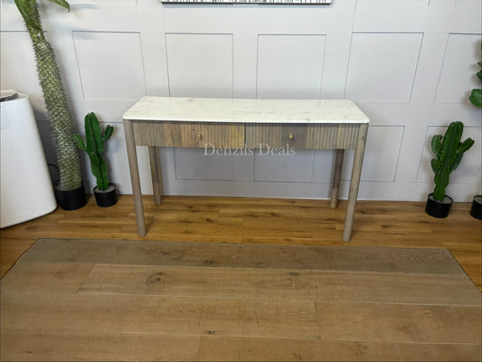 Marmo Marble Top 2 Drawer Console Table with a polished white Indian Carrera marble surface with unique grey and blue veining, Crafted from solid mango wood with a grey-wash finish, two drawers feature striking vertical ribbed textures that provide architectural depth. Finished with elegant round button knobs, typically in brass or gold-toned metal