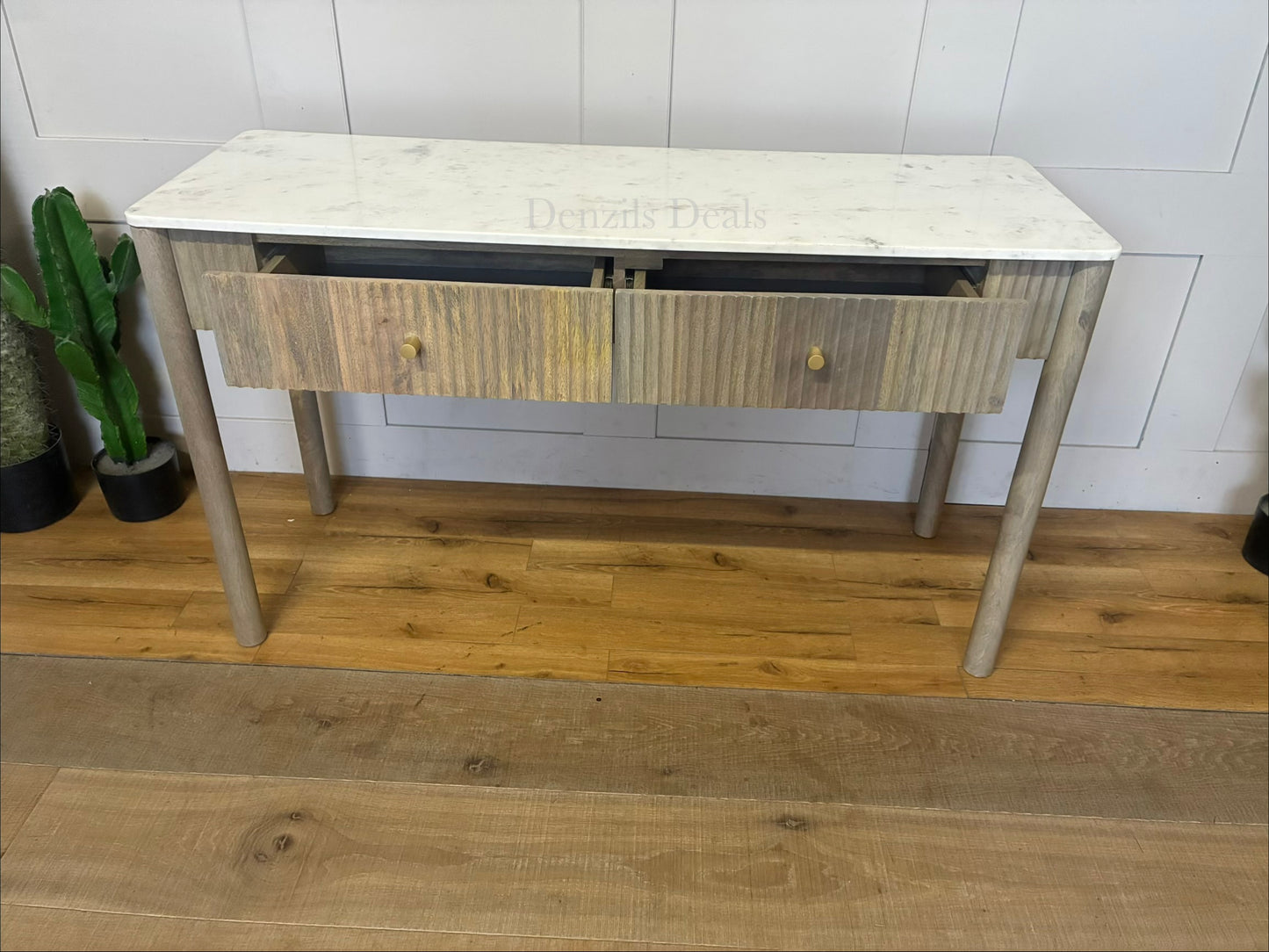 Marmo Marble Top 2 Drawer Console Table with a polished white Indian Carrera marble surface with unique grey and blue veining, Crafted from solid mango wood with a grey-wash finish, two drawers feature striking vertical ribbed textures that provide architectural depth. Finished with elegant round button knobs, typically in brass or gold-toned metal