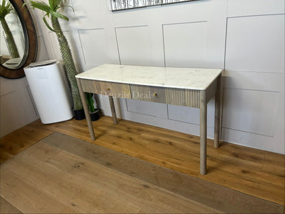 Marmo Marble Top 2 Drawer Console Table with a polished white Indian Carrera marble surface with unique grey and blue veining, Crafted from solid mango wood with a grey-wash finish, two drawers feature striking vertical ribbed textures that provide architectural depth. Finished with elegant round button knobs, typically in brass or gold-toned metal