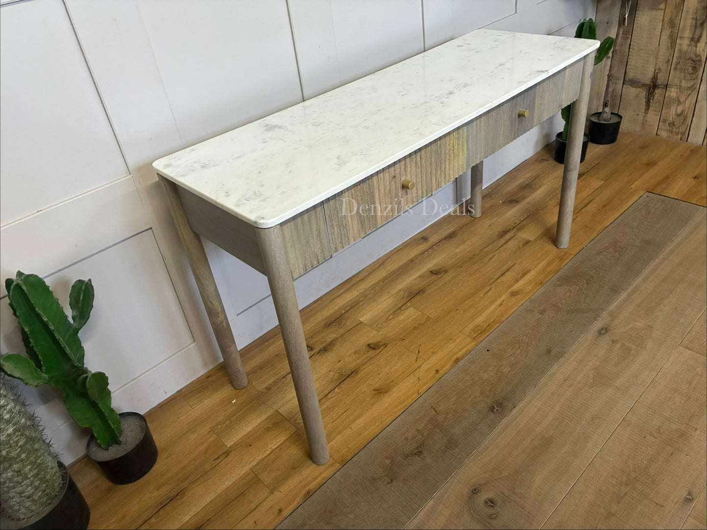 Marmo Marble Top 2 Drawer Console Table with a polished white Indian Carrera marble surface with unique grey and blue veining, Crafted from solid mango wood with a grey-wash finish, two drawers feature striking vertical ribbed textures that provide architectural depth. Finished with elegant round button knobs, typically in brass or gold-toned metal