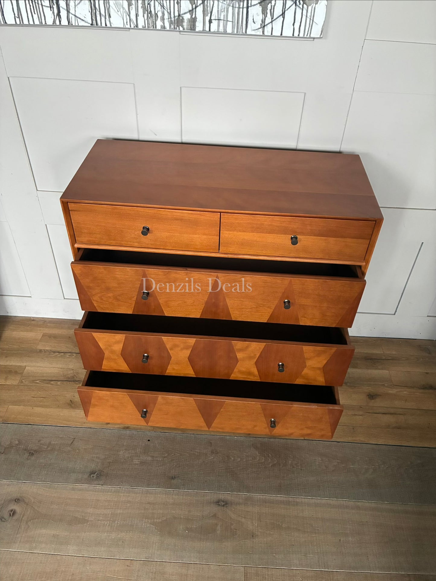 John Lewis Marquetry 5-drawer chest of drawers made of light wood with geometric inlaid wood patterns on the drawer fronts, featuring slim metal legs and minimalist metal handles.