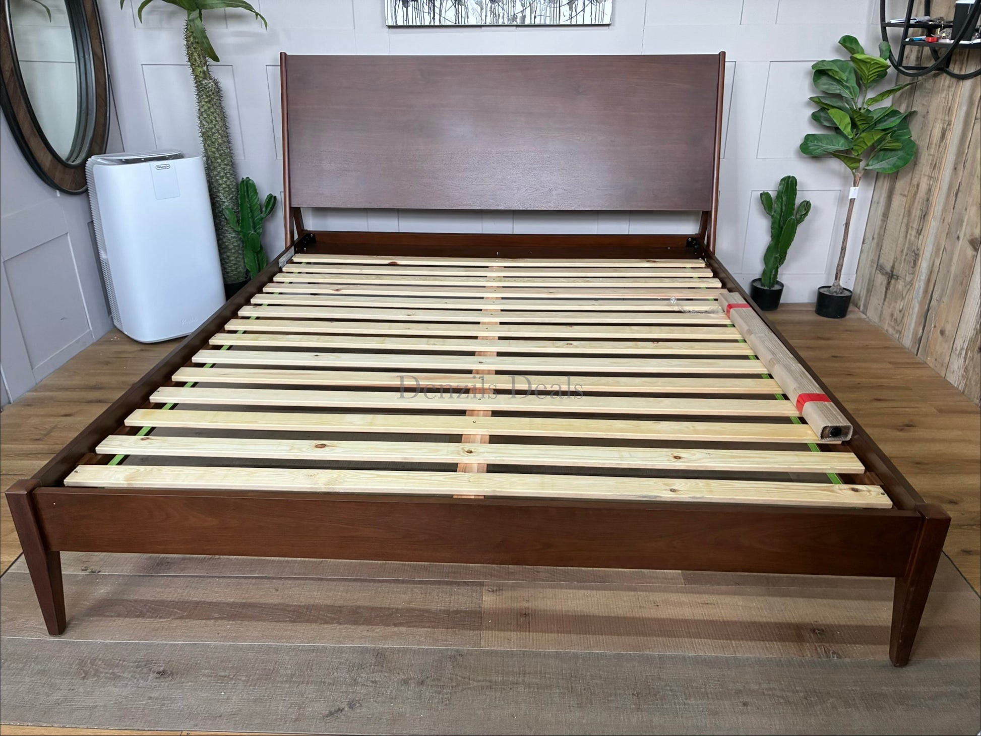 Mid-Century Modern wooden super king bed frame with tapered legs and doweled headboard edges from West Elm"