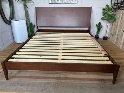 Mid-Century Modern wooden super king bed frame with tapered legs and doweled headboard edges from West Elm"