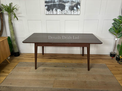 Mid-century modern dark walnut wooden dining table with a smooth rectangular top and tapered legs, designed to seat four to six people.
