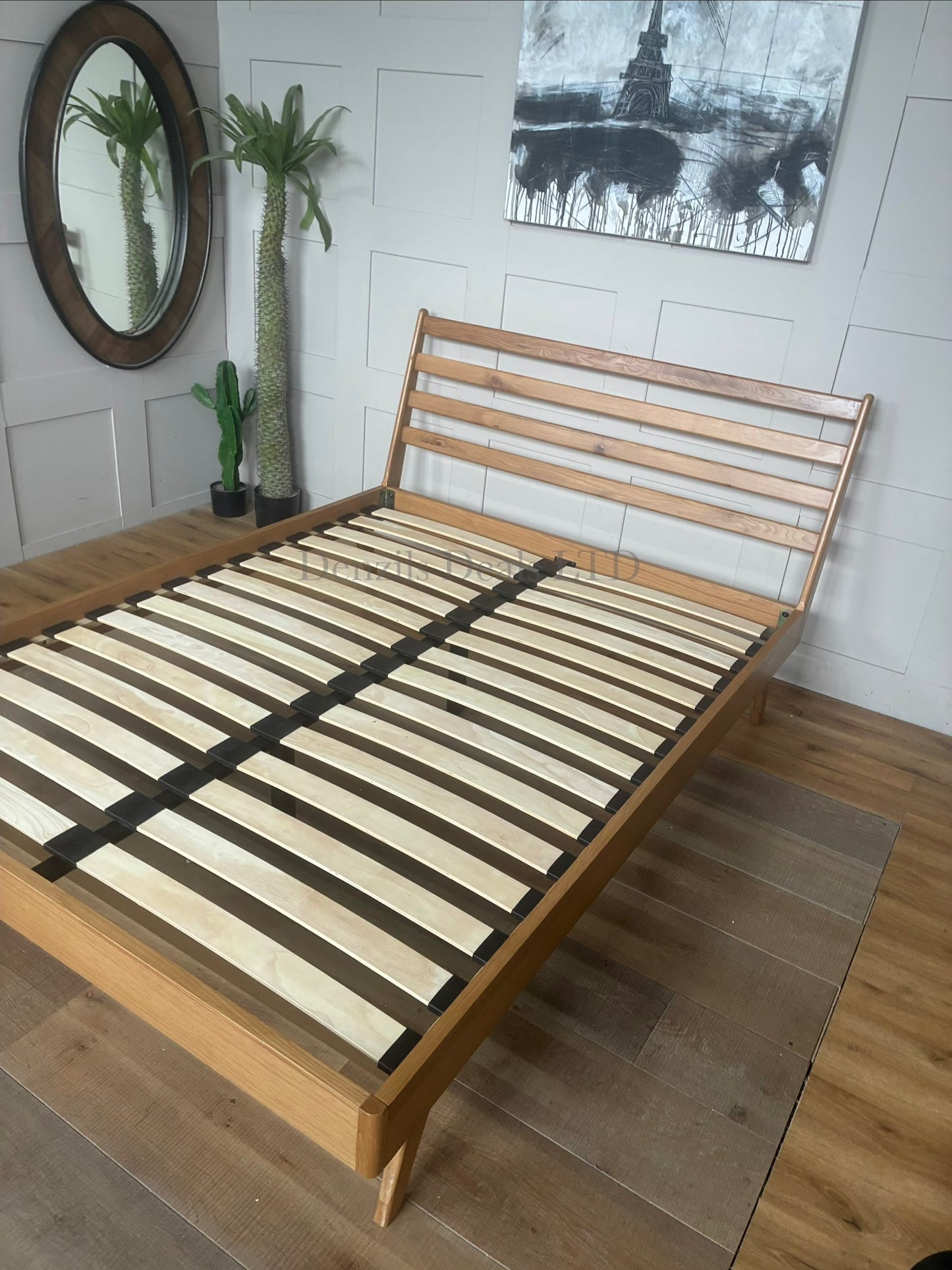 Mid-century modern king-size bed frame from the John Lewis X-Ray collection, featuring a sturdy oak wood frame, tapered legs, and a padded upholstered headboard in mandarin orange fabric with a smooth, curved silhouette.