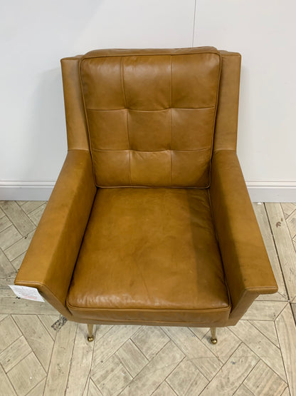 Mid-century style brown leather armchair with buttoned back and polished gold legs"