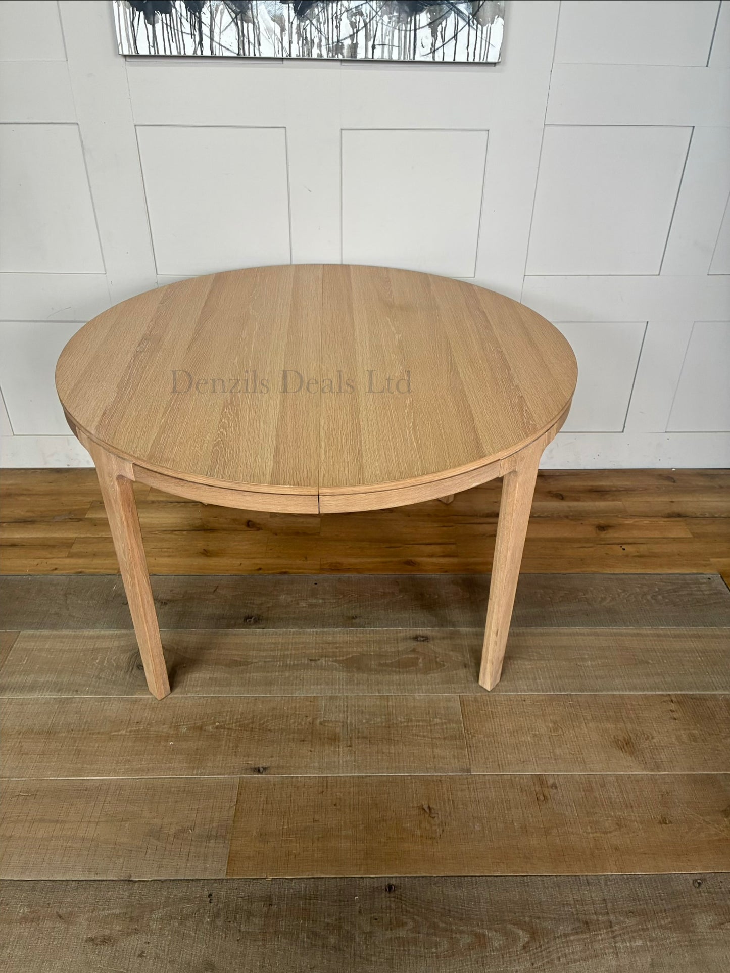 Modern dining room featuring the John Lewis Mira II round oak dining table surrounded by matching chairs on a neutral rug.
