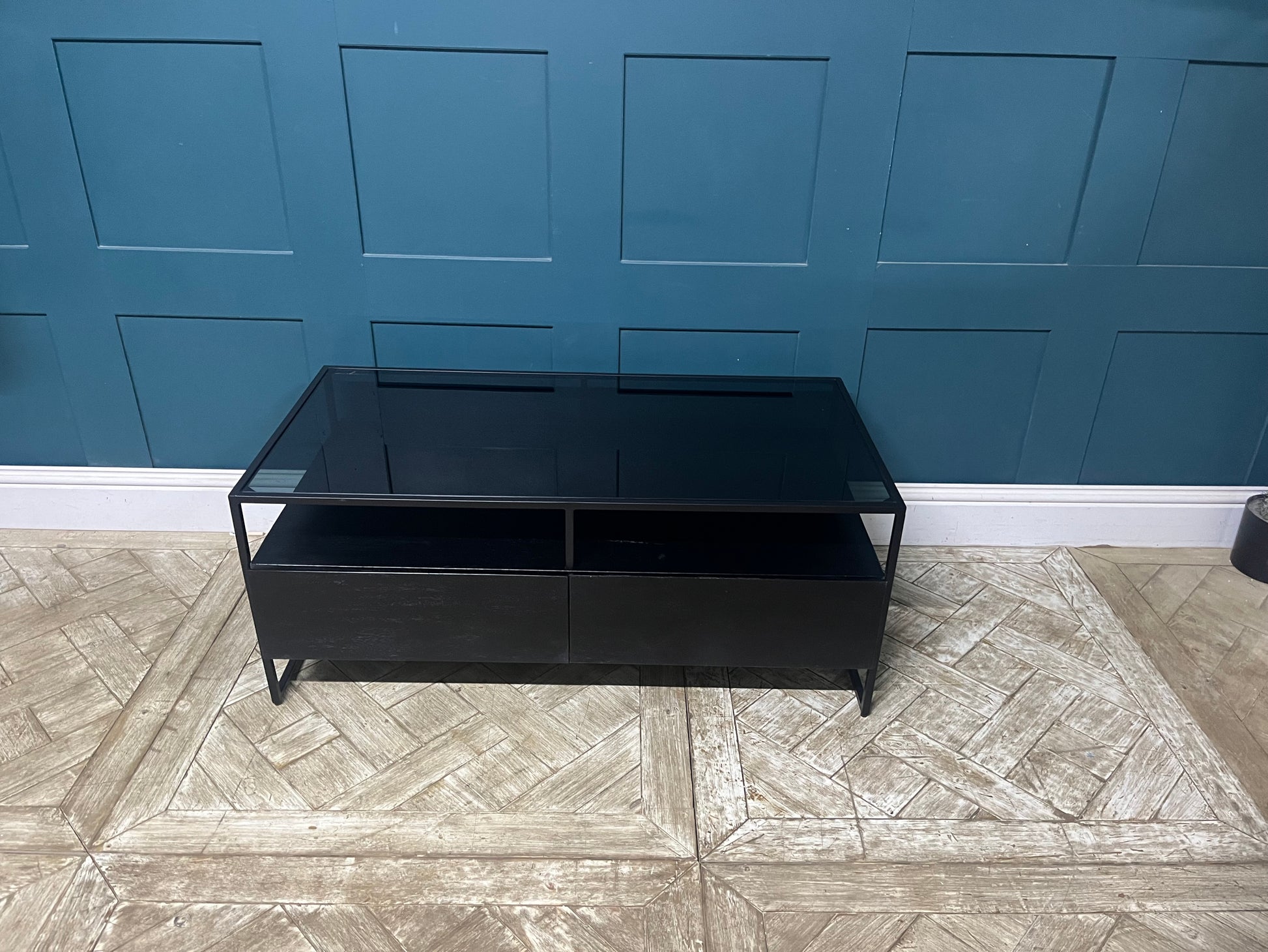 Modern Kilby coffee table by Made.com featuring black metal lines and a sleek smoked glass top