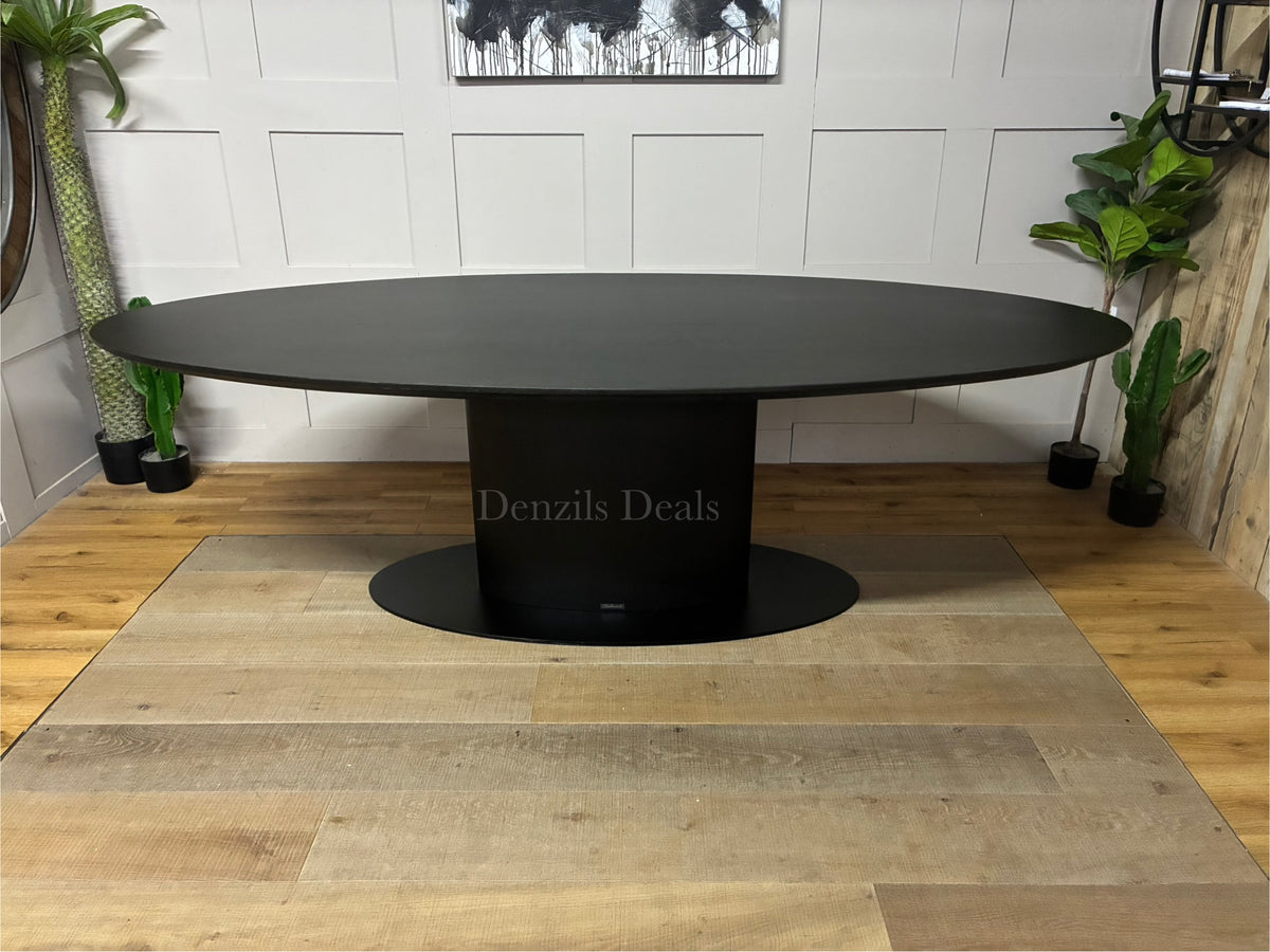 Modern Richmond Interiors Gordon 250cm dining table in a rich dark coffee oak finish, featuring a thick rectangular tabletop resting on a bold, central iron pedestal base.