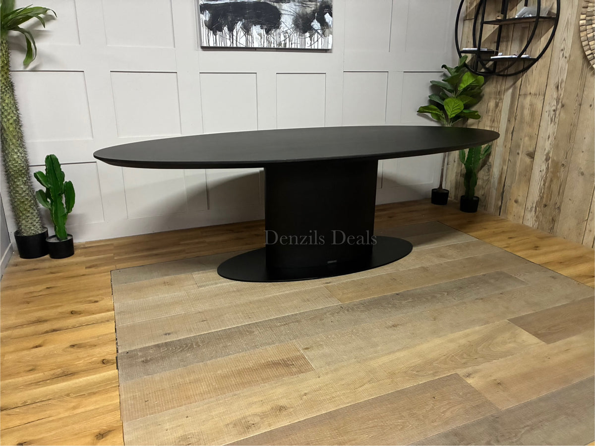 Modern Richmond Interiors Gordon 250cm dining table in a rich dark coffee oak finish, featuring a thick rectangular tabletop resting on a bold, central iron pedestal base.