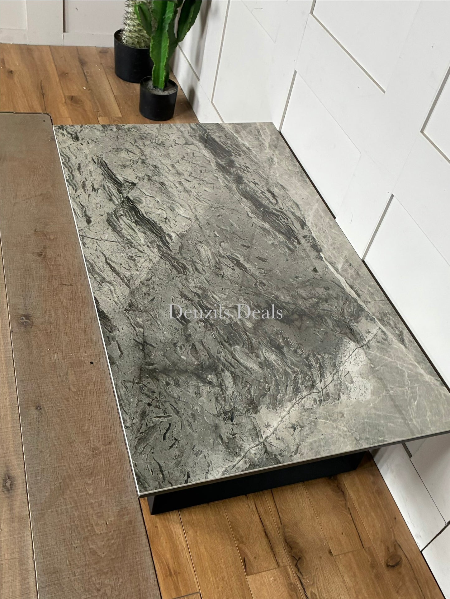 Modern Teno coffee table featuring a coated grey stone and ceramic top with geometric steel legs.