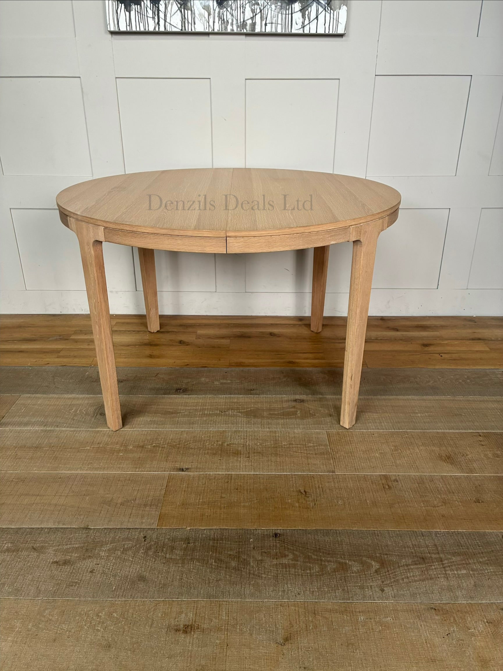 Modern dining room featuring the John Lewis Mira II round oak dining table surrounded by matching chairs on a neutral rug.
