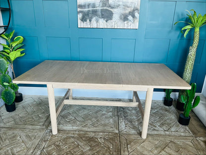 Modern farmhouse-style light oak extendable dining table with clean lines, subtly rounded rectangular top, and straight legs