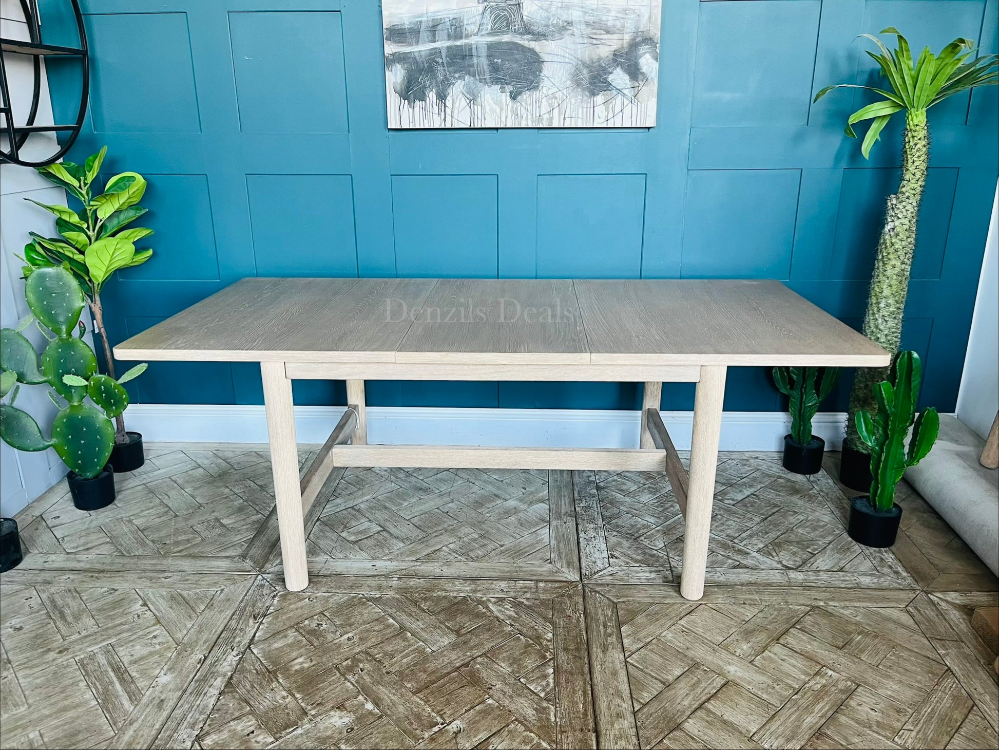 Modern farmhouse-style light oak extendable dining table with clean lines, subtly rounded rectangular top, and straight legs