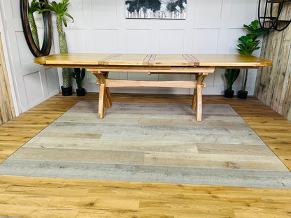 Modern featuring a large, fully extended Hercules oak dining table with seating for 12, highlighting natural wood grain details.