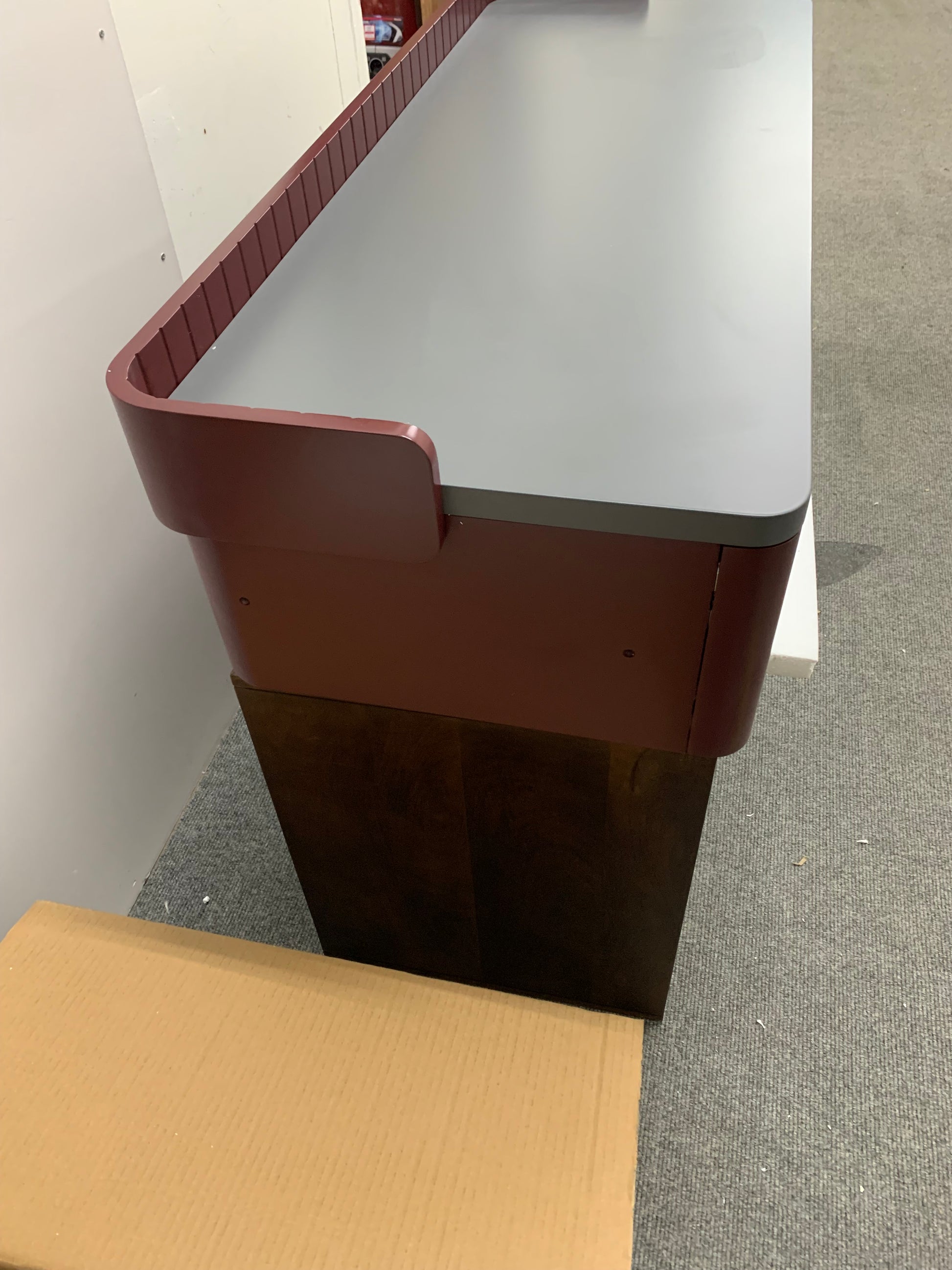 Modern home office setup featuring the Made.com Lali wide desk in grey and mahogany red.