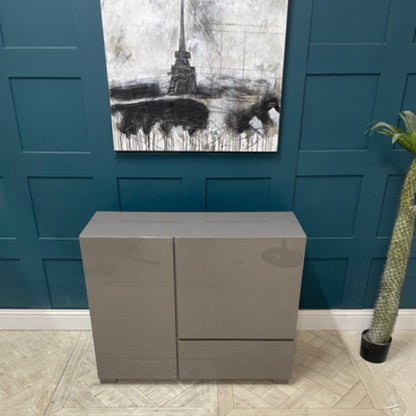 Modern minimalist Dwell Olmo stone-coloured cupboard featuring a sleek high-gloss lacquer finish and geometric silhouette. Front view 