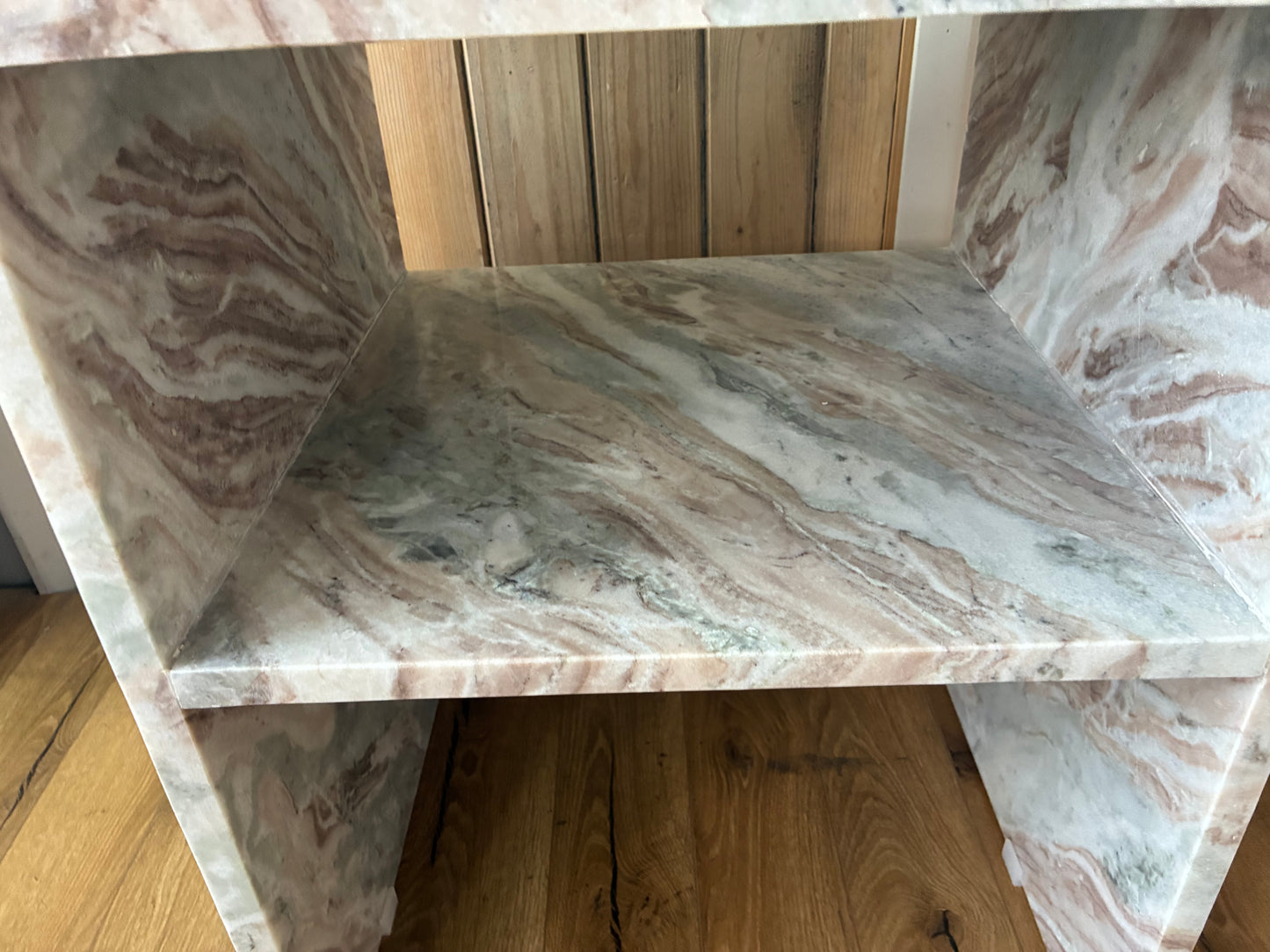 Modern minimalist cube side table crafted from solid natural marble with distinct grey veining. The table features an open, hollow center with thick marble slabs forming the top, sides, and base, offering a clear view through the open sides