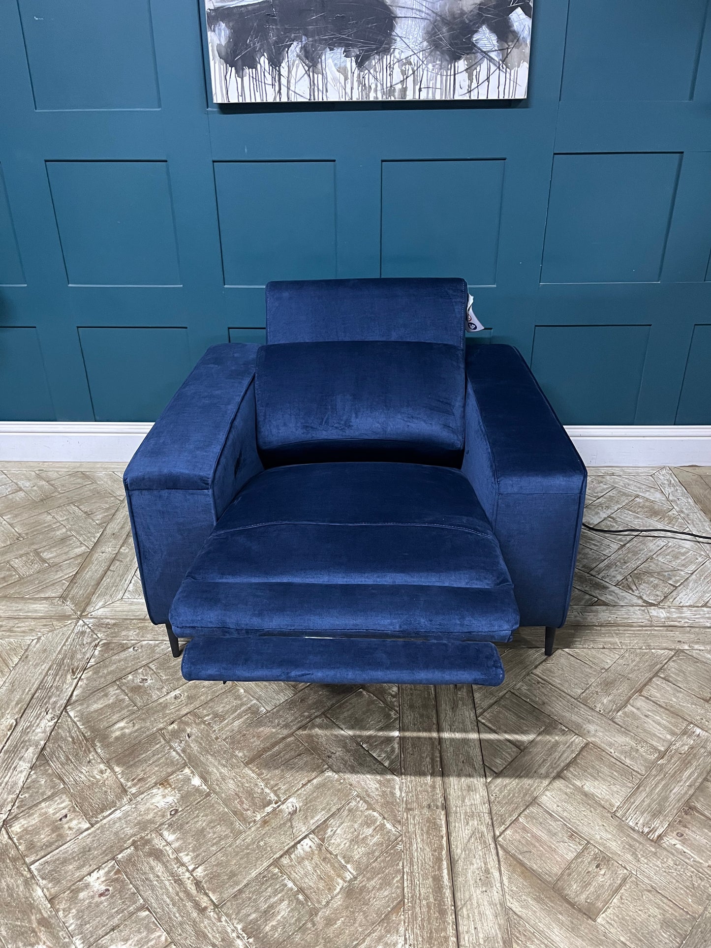 Modern navy blue power reclining armchair upholstered in soft, textured chenille fabric By John Lewis 