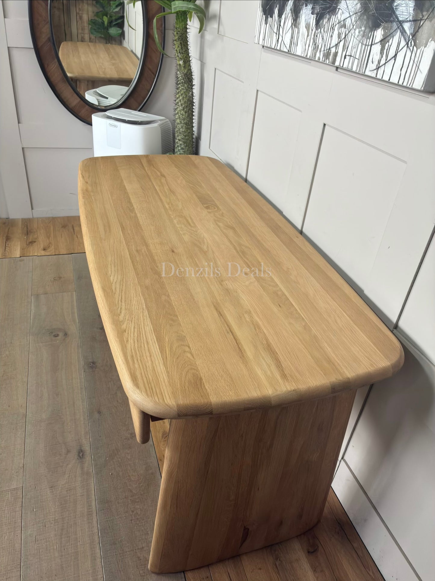 Modern oak Kalle desk with rounded edges, styled in a cozy home office setting with a desk lamp.