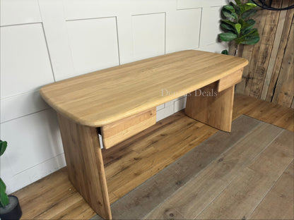 Modern oak Kalle desk with rounded edges, styled in a cozy home office setting with a desk lamp.