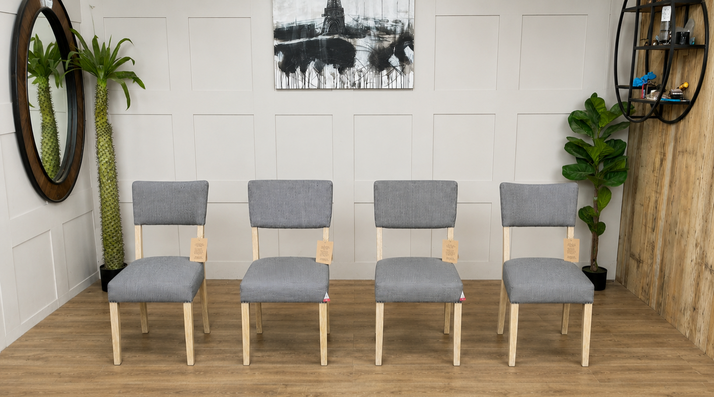 Modern rustic dining chair with a square cushioned seat and a low rectangular backrest upholstered in textured grey-and-white striped linen, supported by a natural mango wood frame with curved back legs.