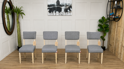 Modern rustic dining chair with a square cushioned seat and a low rectangular backrest upholstered in textured grey-and-white striped linen, supported by a natural mango wood frame with curved back legs.
