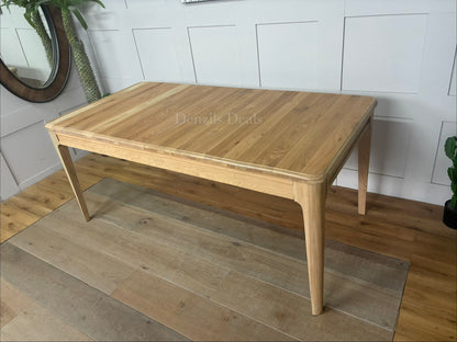 Close-up of the pale matt finish and smooth solid oak grain on the NEWTON extendable dining table."