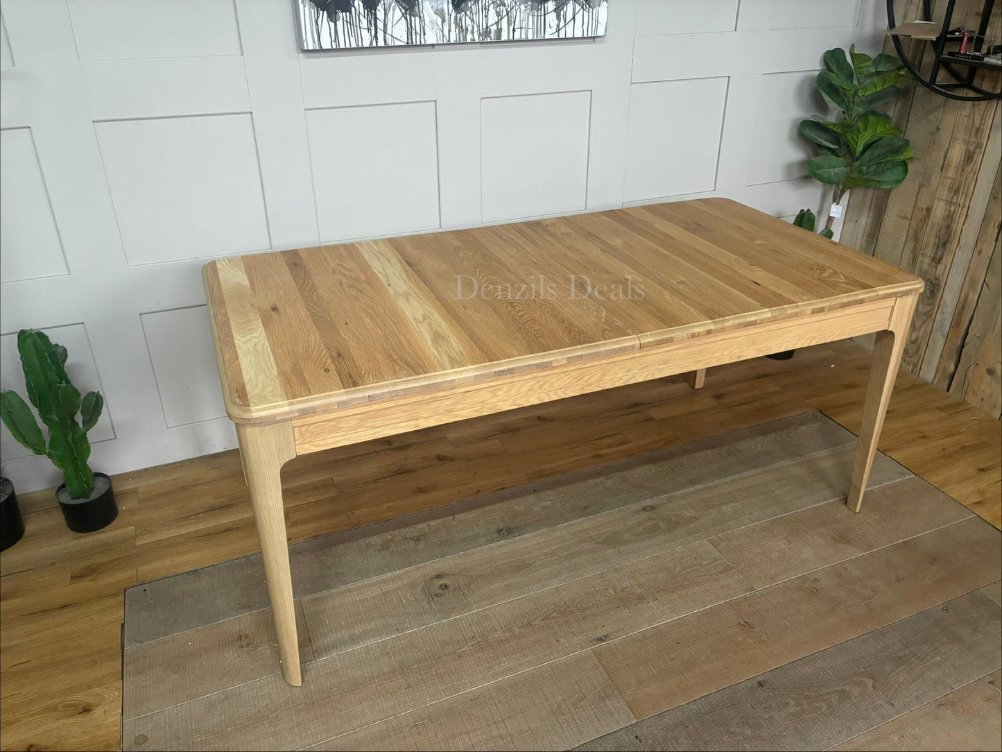 NEWTON light natural solid oak 6 to 8 seater extendable dining table with a pale oak finish."