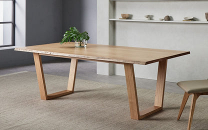 A modern Nick Scali Blox Dining Table featuring a smooth Australian oak wood top and striking geometric angular legs