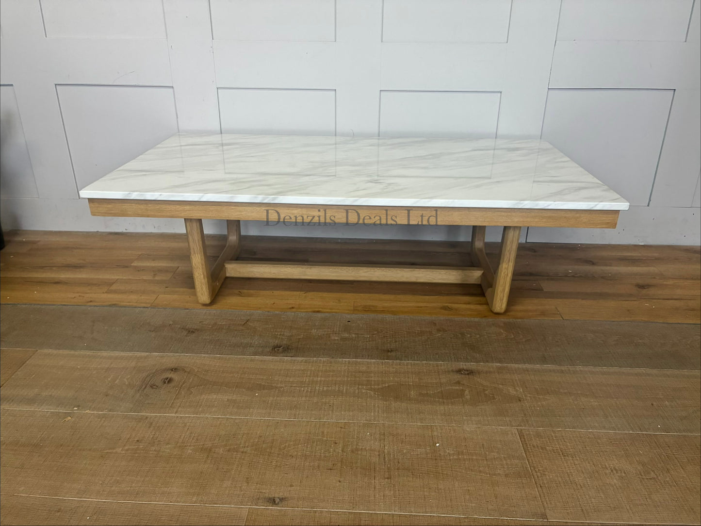 Nick Scali Carlina coffee table featuring a rectangular white marble top and a warm-toned solid wood apron with sleek rounded timber legs."
